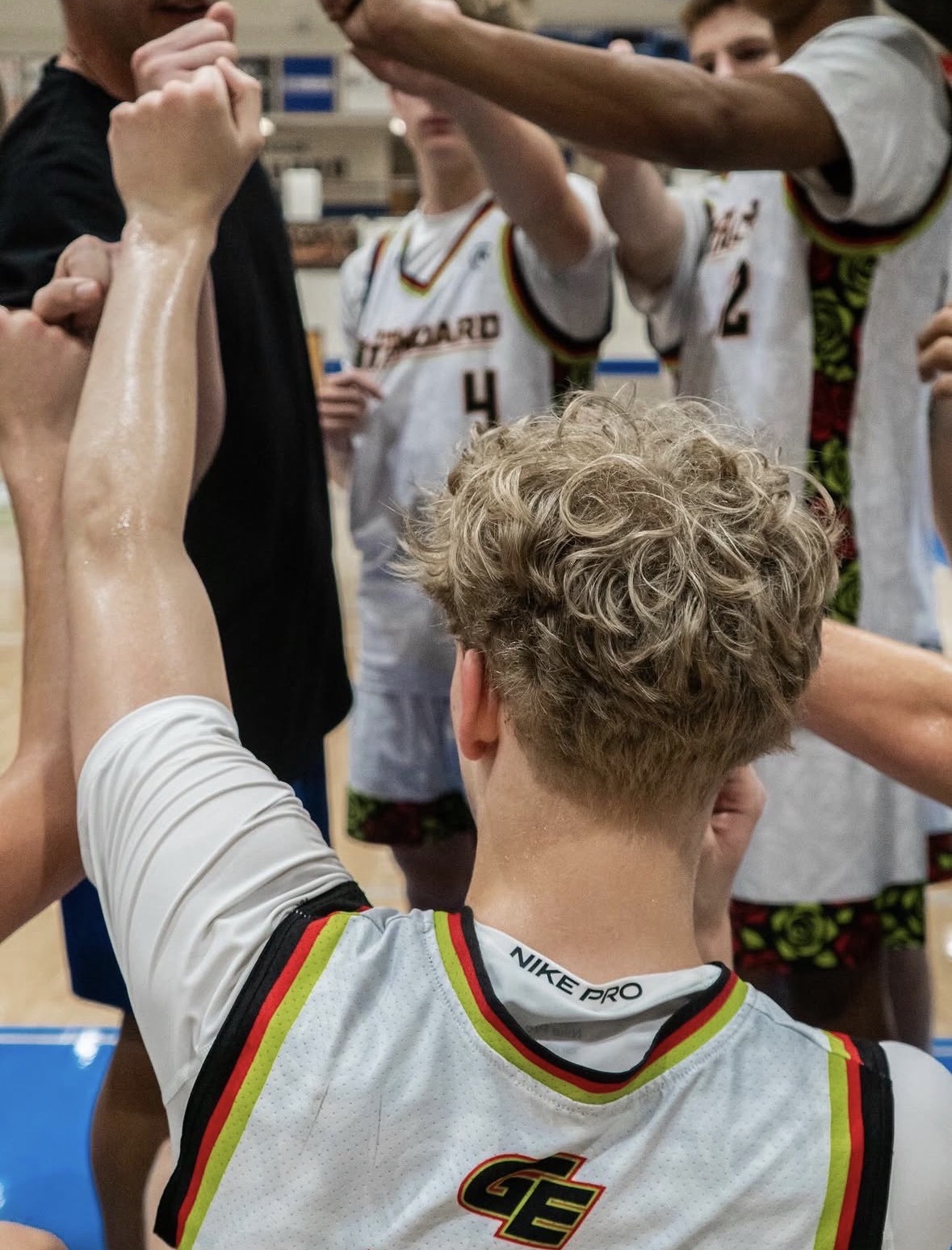 Atlanta travel basketball team huddle raising fists together
