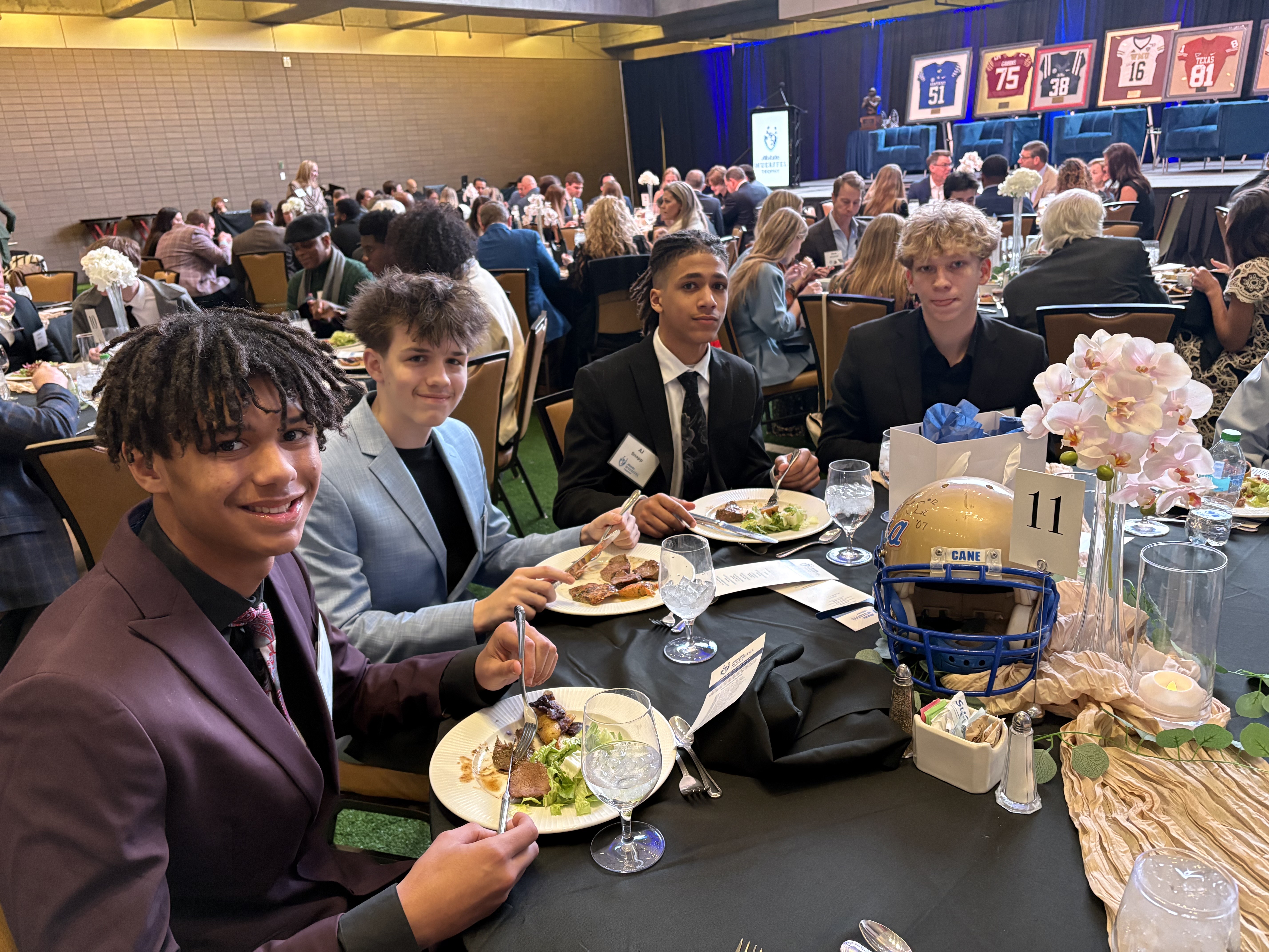 Players seated at dinner table during the gala